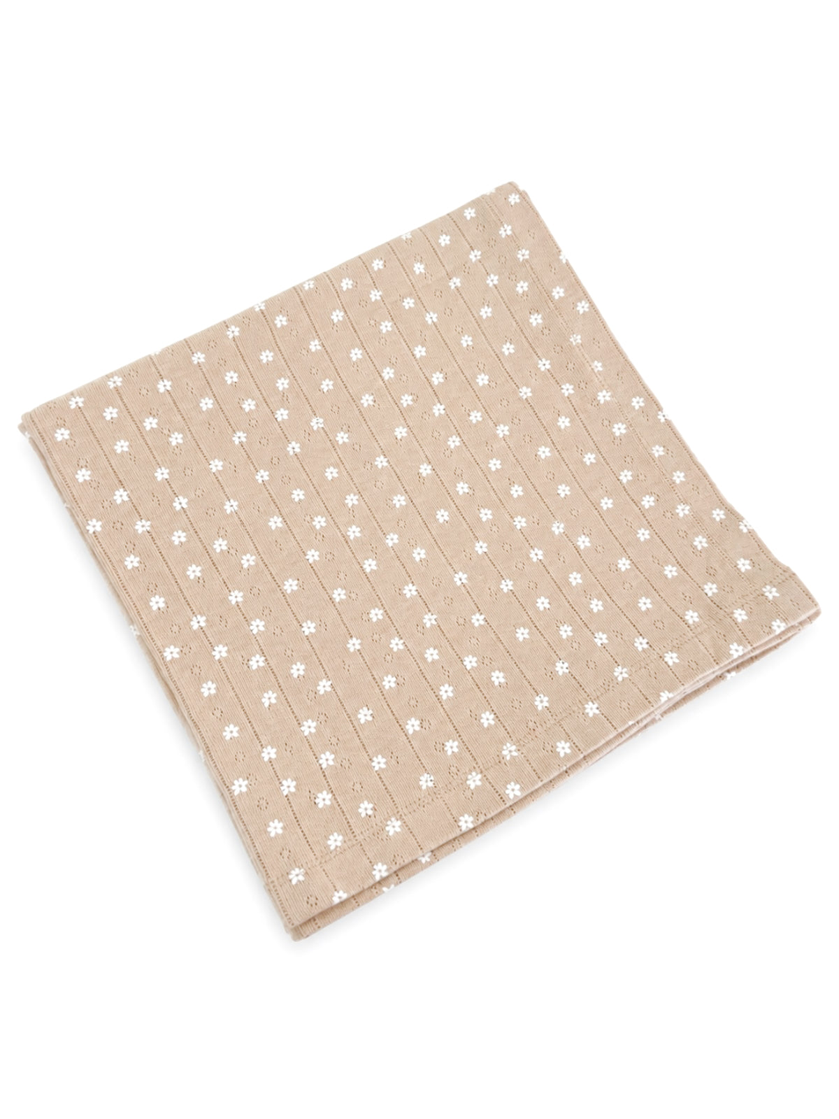 Beige fabric square with white floral patterns, folded neatly. Ideal for home decor or crafting projects.