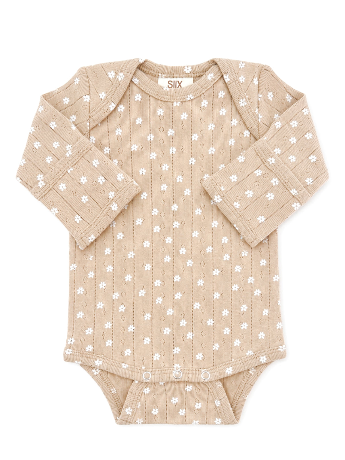 Tan baby bodysuit with white floral pattern and long sleeves, featuring snap closures at the bottom.