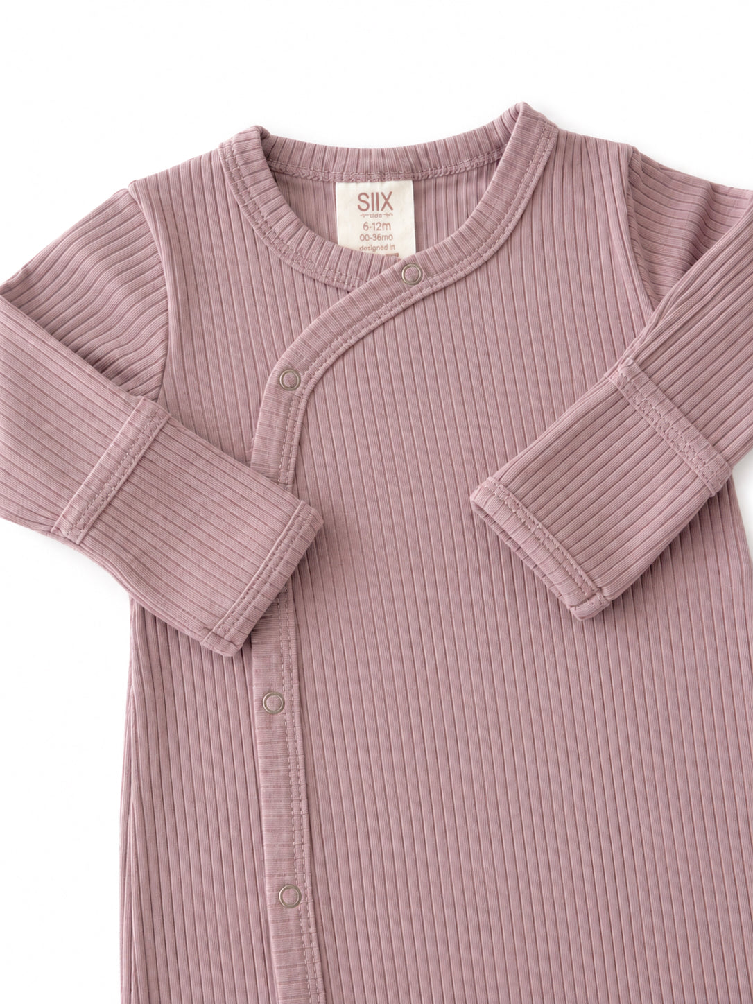 Light purple ribbed baby onesie with snap buttons and long sleeves. Suitable for ages 6 to 12 months.