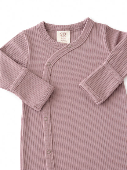 Light purple ribbed baby onesie with snap buttons and long sleeves. Suitable for ages 6 to 12 months.