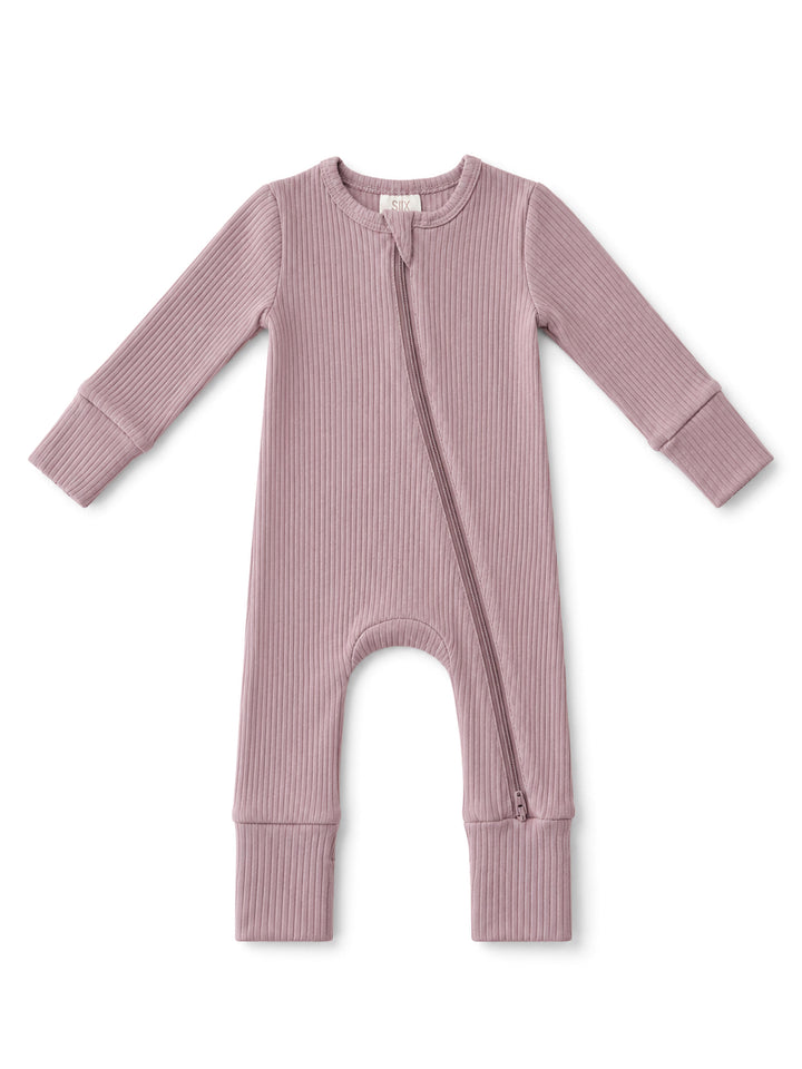 Light mauve baby onesie with long sleeves and a front zipper, featuring ribbed texture.