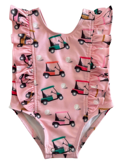 Pink ruffled swimsuit featuring colorful golf cart and golf ball patterns, ideal for summer fun.
