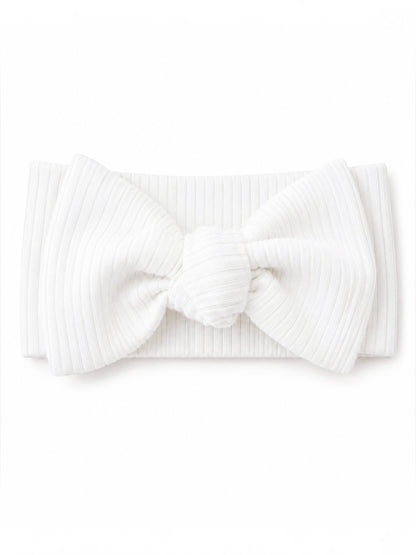 White ribbed headband with a large bow detail in the center.