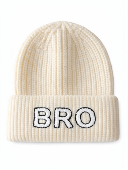 Cream-colored knit beanie with "BRO" embroidered in black on the front.