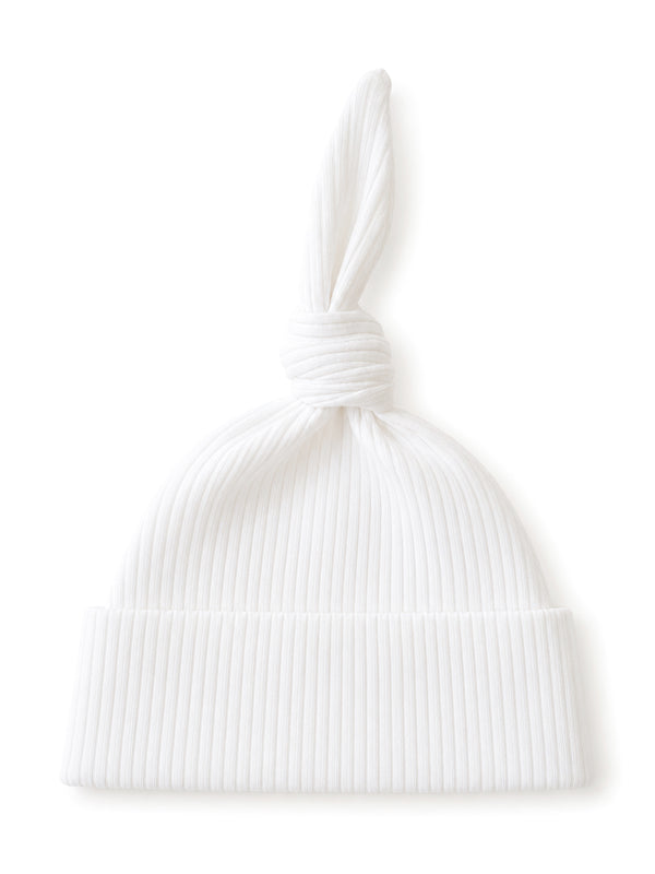 White ribbed hat with a knotted top, designed for a stylish and cozy look.