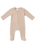 Beige ribbed baby onesie with long sleeves and front zipper closure, featuring footed design.