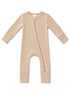 Beige ribbed baby onesie with a front zipper and long sleeves, ideal for comfort and easy dressing.
