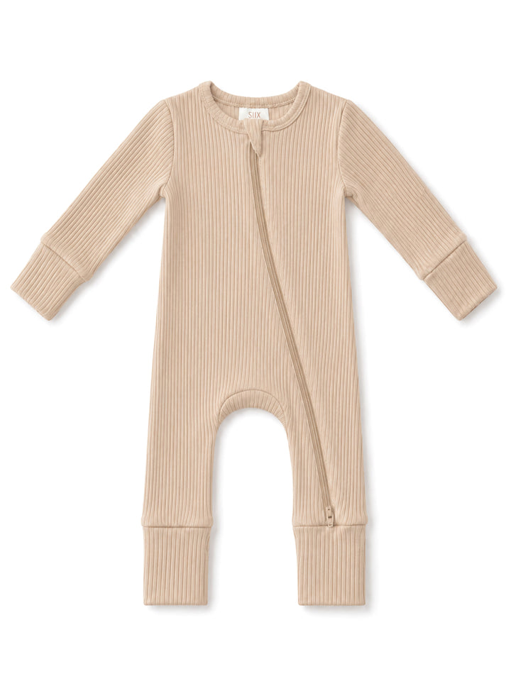 Beige ribbed baby onesie with a front zipper and long sleeves, ideal for comfort and easy dressing.
