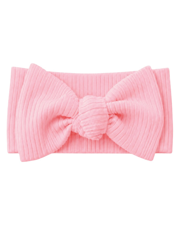 Pink ribbed headband with a large bow centerpiece, perfect for accessorizing outfits.