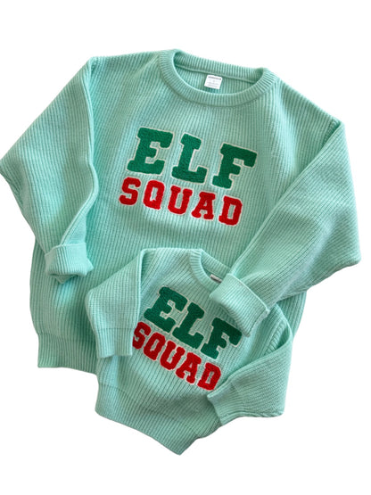 Matching mint green sweaters for kids and adults with "ELF SQUAD" in colorful letters.
