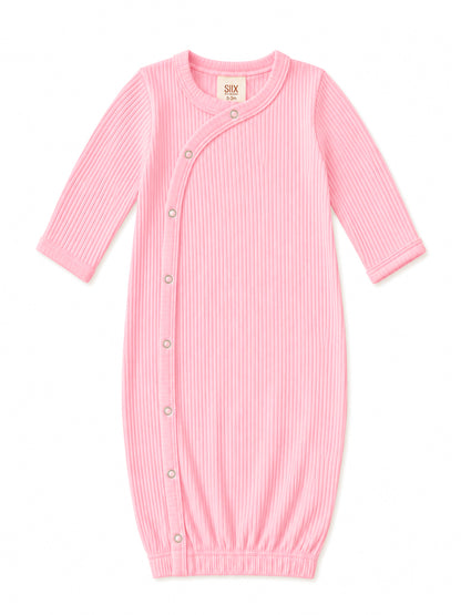 Light pink baby sleeping gown with ribbed texture and snap buttons for easy dressing. Suitable for infants 0-3 months.