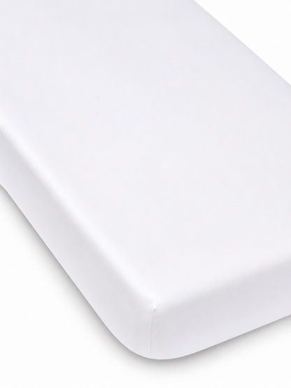 White mattress corner on a light background, featuring a smooth, clean finish. Ideal for a minimalist aesthetic.