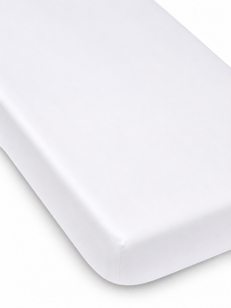 White mattress corner on a light background, featuring a smooth, clean finish. Ideal for a minimalist aesthetic.