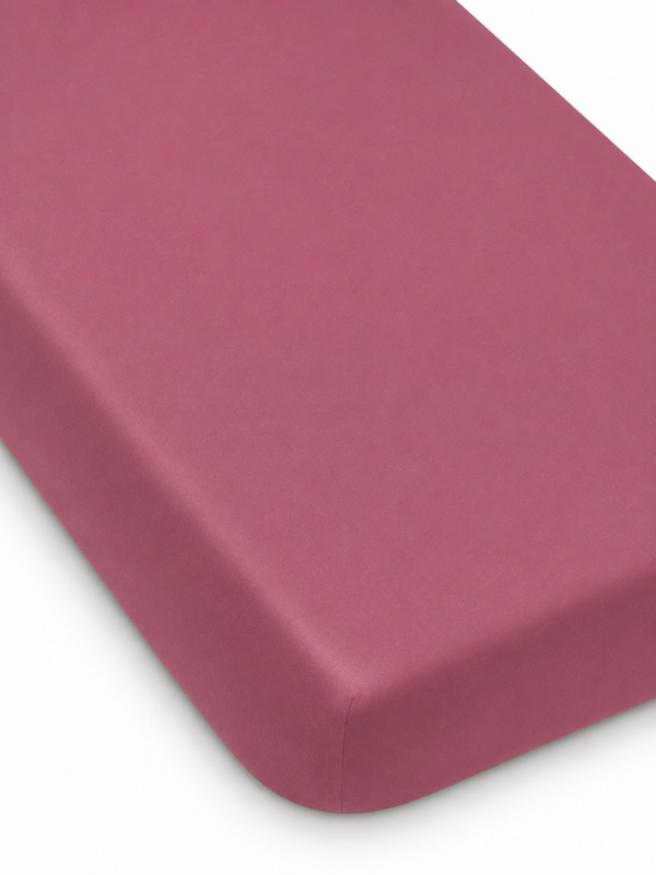 Solid color burgundy mattress corner with smooth edges.
