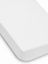 White fitted sheet with navy blue polka dots, showcasing texture and neat edges. Ideal for bedding decor.