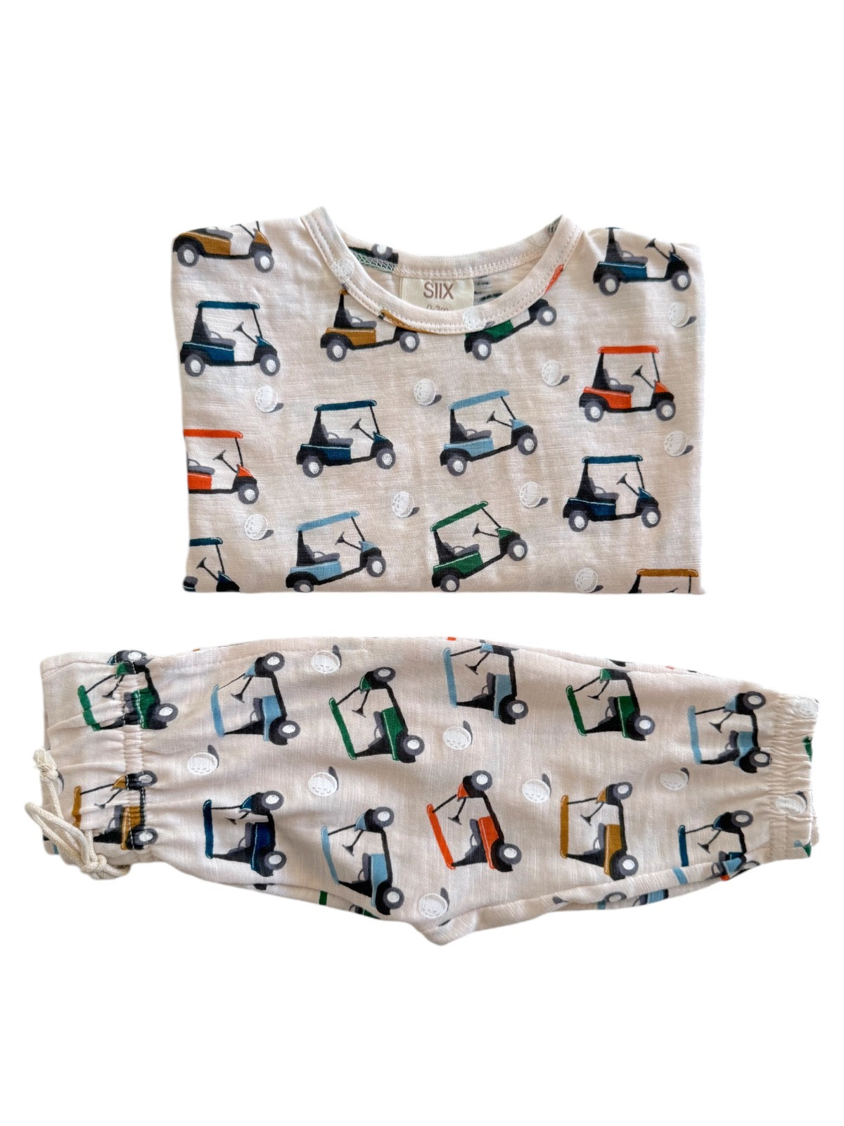 Children's pajama set with golf cart patterns on a light background. Includes a shirt and pants.