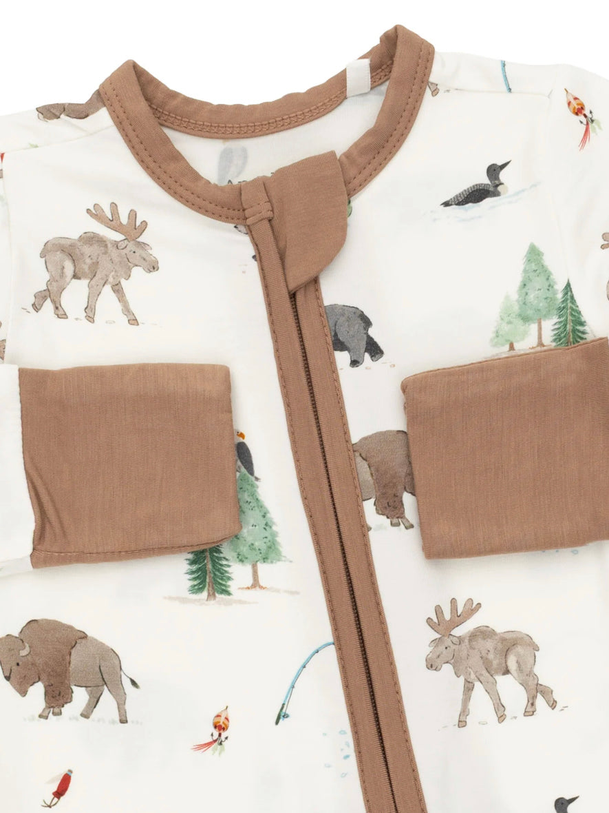 Brown zip-up baby bodysuit with colorful animal and nature patterns, featuring moose, bears, and trees.