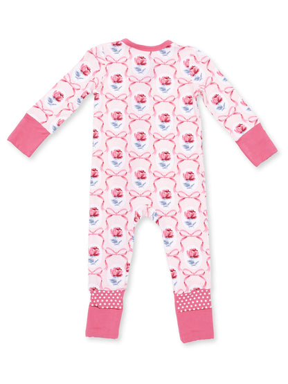 Back view of pink floral-patterned children's pajamas with long sleeves and polka-dot trim.