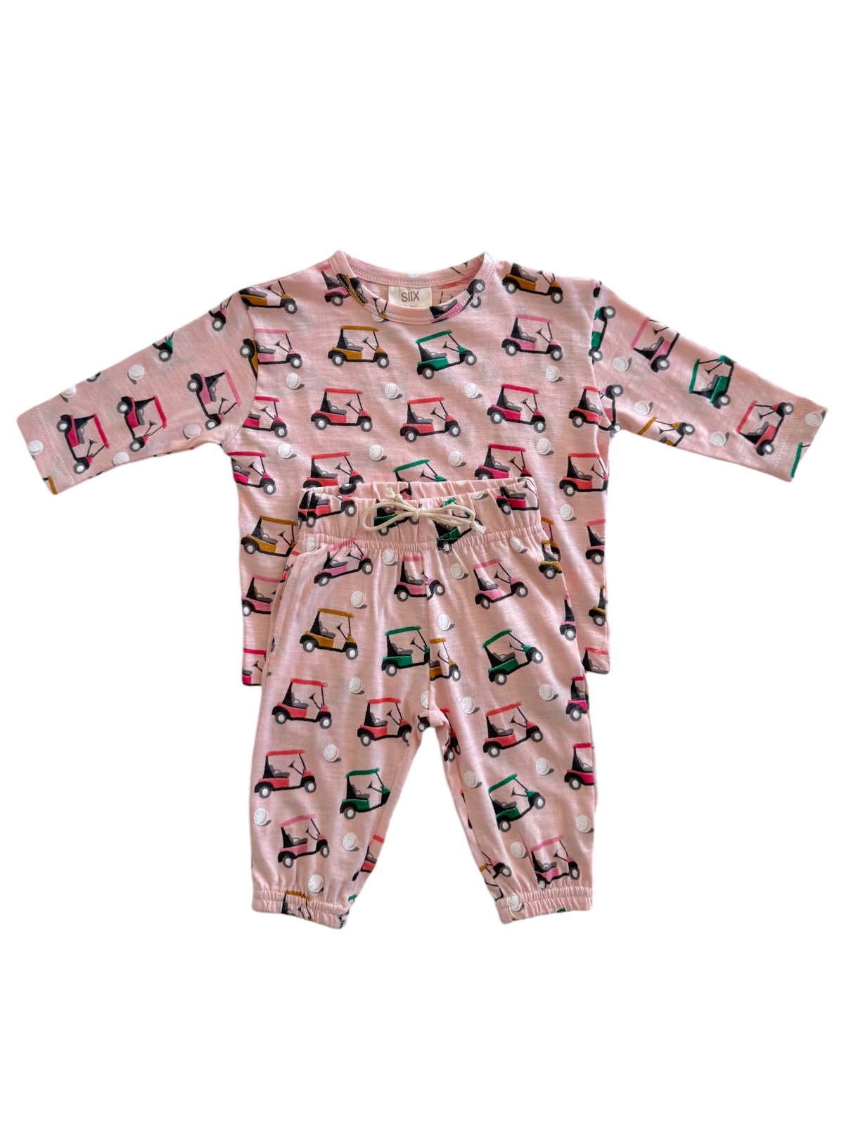 Pajama set for kids featuring a playful golf cart print on a pink background.