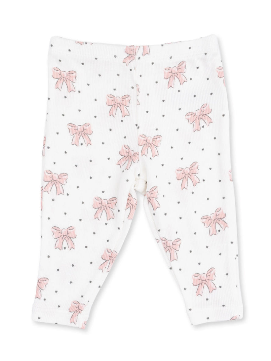 White leggings with pink bows and black dots pattern.