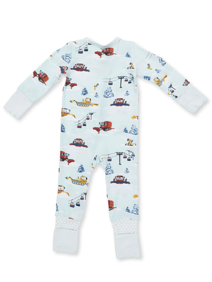 Pajamas with a playful winter scene featuring snow vehicles, trees, and ski lifts on a light blue background.