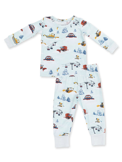 Kids' pajama set featuring playful winter-themed prints with snowplows, ski lifts, and snow-covered trees.