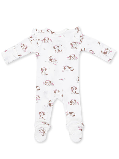 White baby onesie with playful puppy prints and floral accents, featuring long sleeves and footed design.
