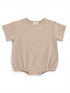 Light beige baby onesie with short sleeves and snap closures at the bottom, featuring a textured fabric.