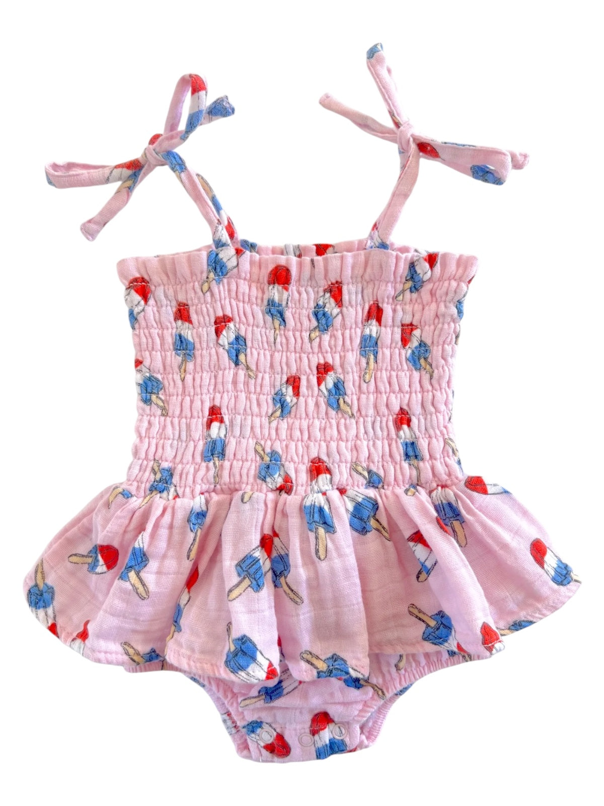 Pink baby romper with ice cream print and tie straps, featuring a smocked bodice and ruffled skirt.