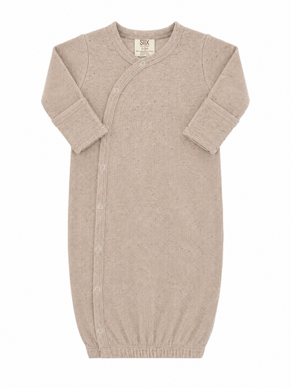 Light beige newborn sleep sack with ribbed texture and snap buttons, designed for comfort and ease of use.