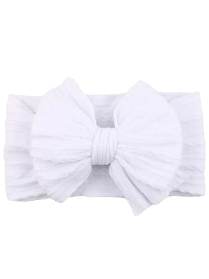 White headband with a large bow, featuring soft textured fabric and a stretchy band.