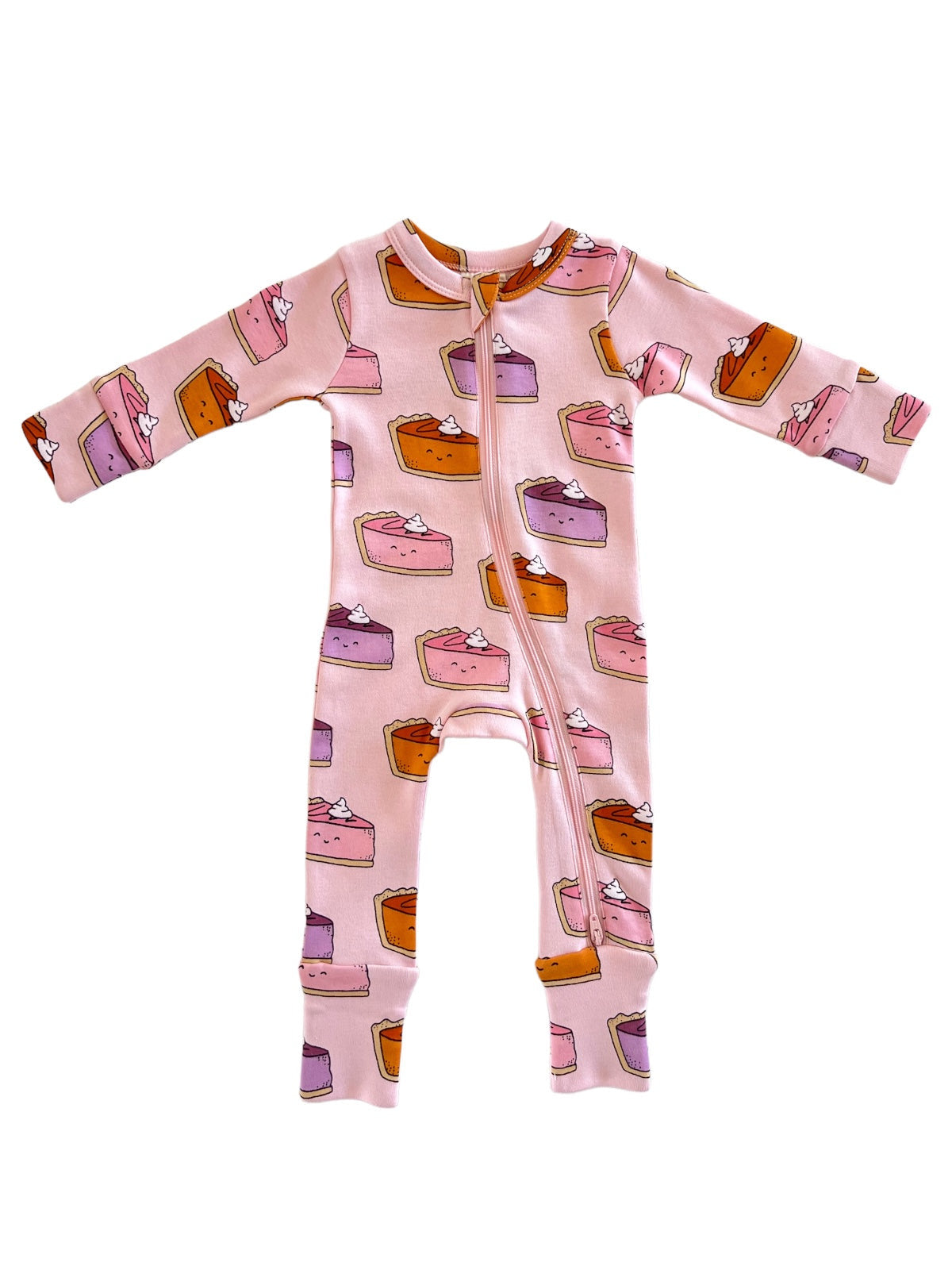 Pink onesie with a dessert pattern featuring various cake slices and whipped cream.