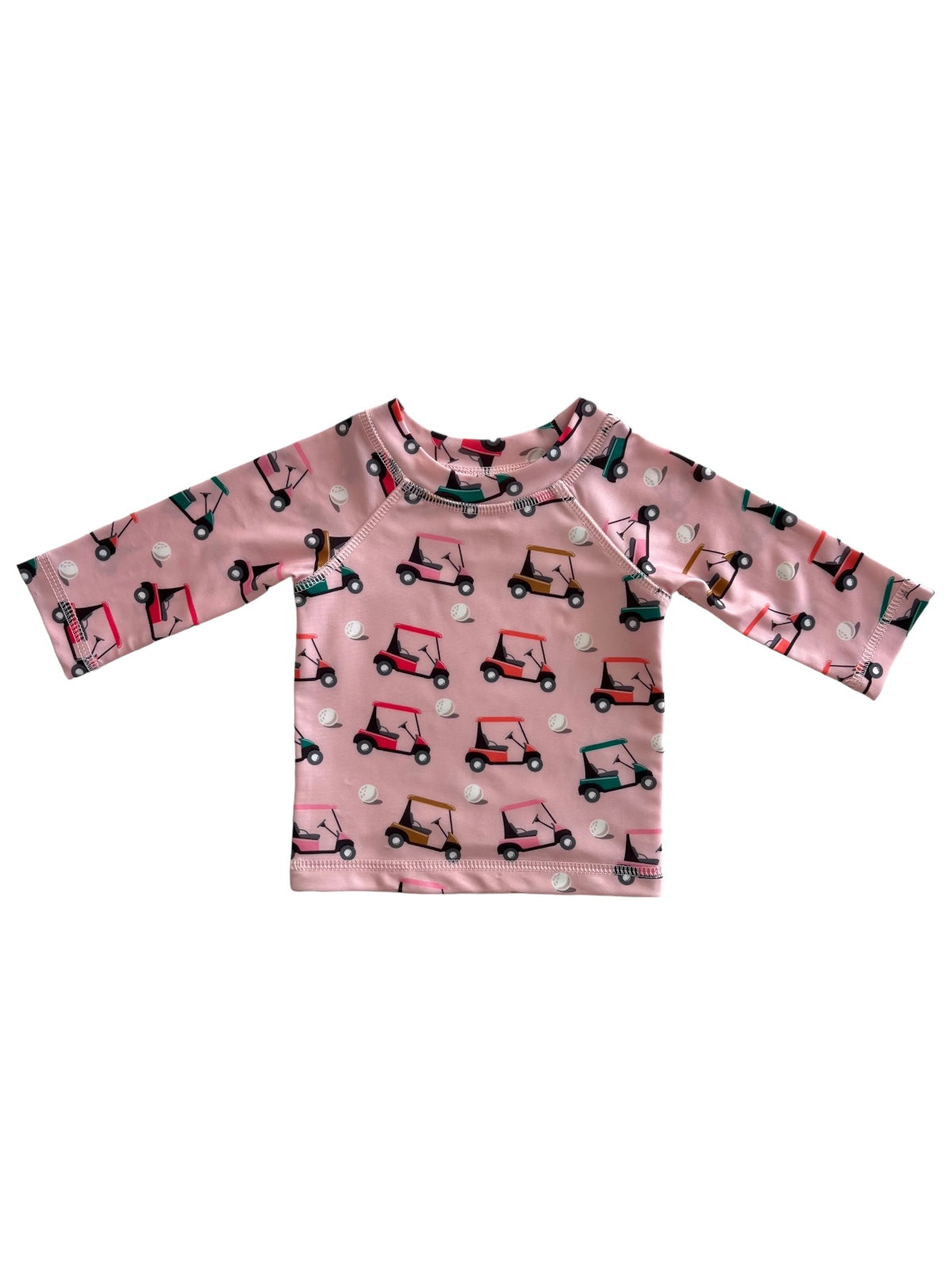 Pink long-sleeve shirt with a playful golf cart print and round neckline. Perfect for casual wear.