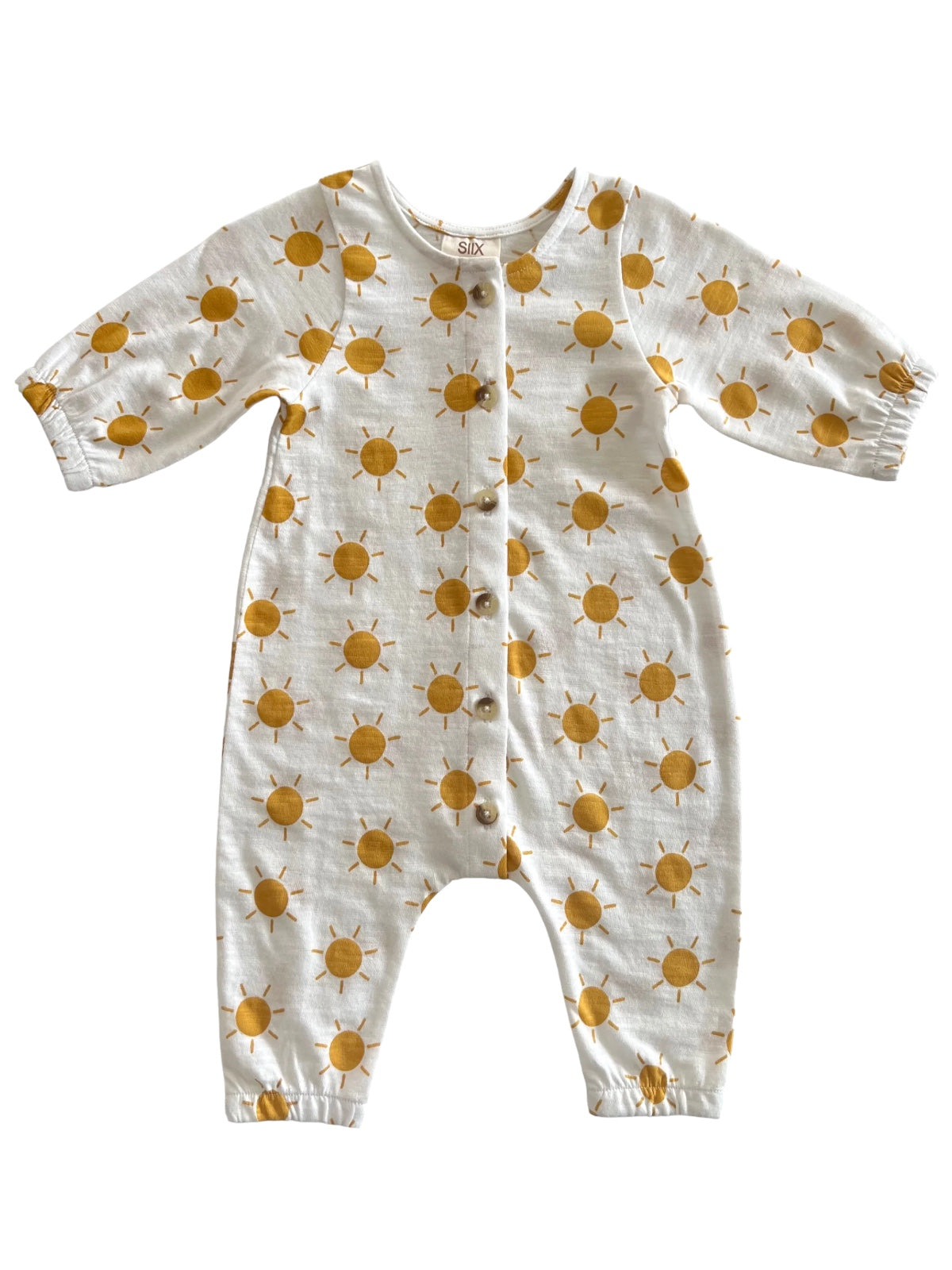 White baby onesie with yellow sun patterns and button closure. Ideal for warm weather and comfy play.