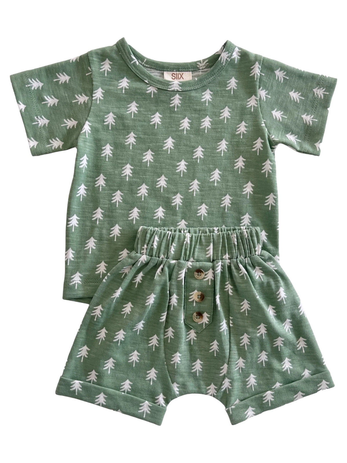Green toddler outfit with tree pattern, featuring a short-sleeve shirt and matching shorts with button details.