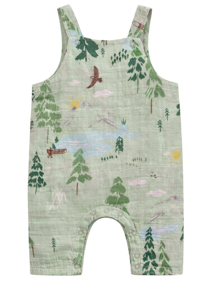 Green toddler overalls featuring a nature print with trees, sun, mountains, and a canoe design.