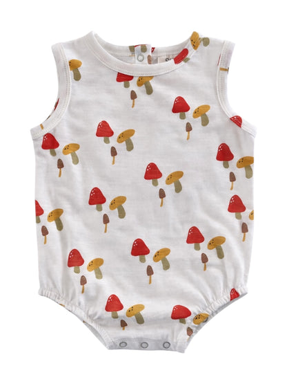 White baby romper with colorful mushroom print in red, yellow, and brown tones.