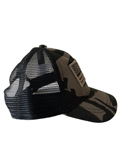 Camo trucker hat with mesh back, viewed from the side, featuring a patch on the front.