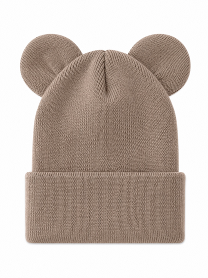 Tan knit beanie with bear ears, featuring a folded cuff design and textured fabric. Ideal for winter wear.