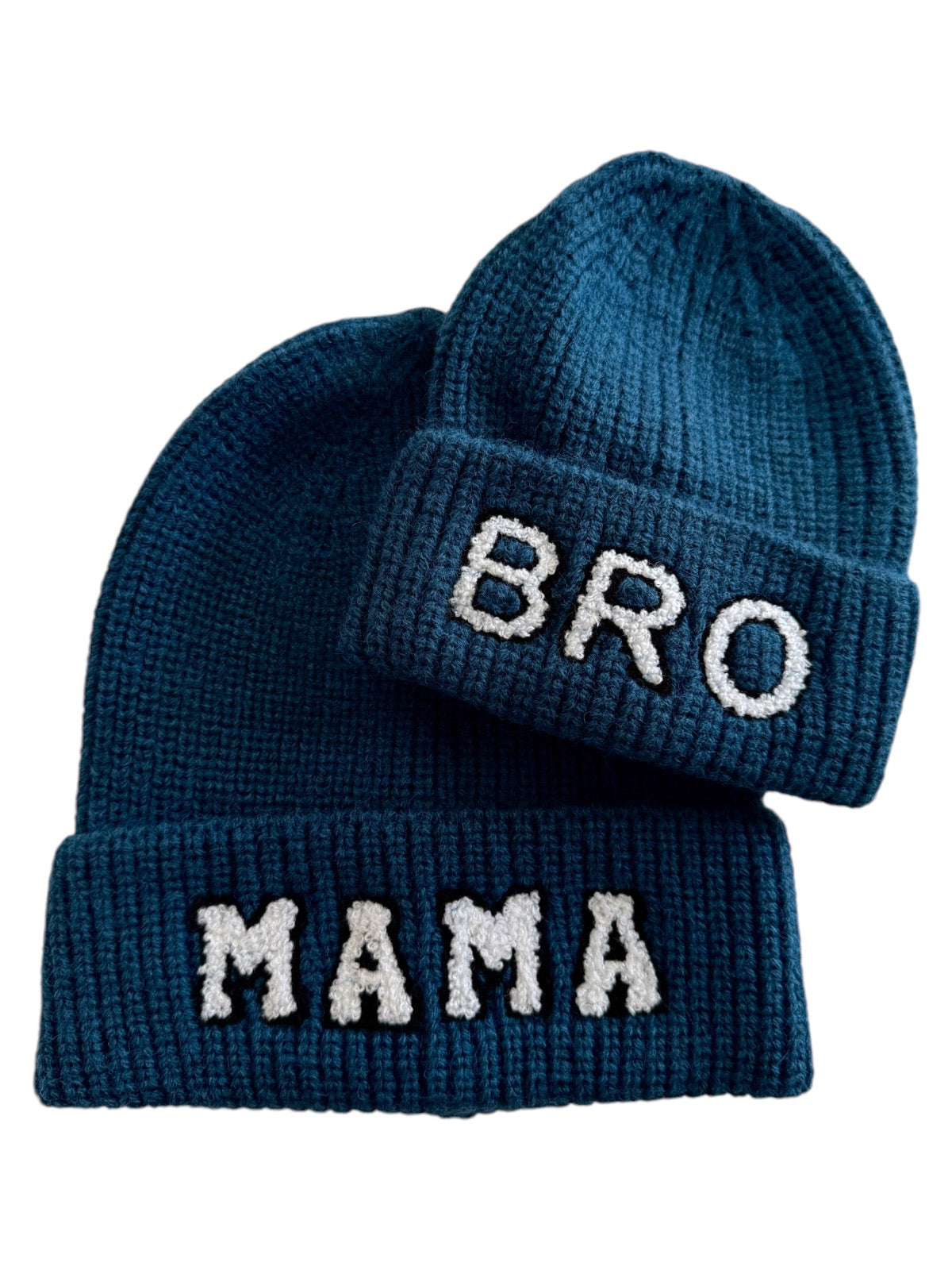Two knitted beanies in dark blue, one labeled "BRO" and the other "MAMA."