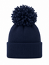 Navy knitted beanie with a large fluffy pom-pom on top and a folded brim.