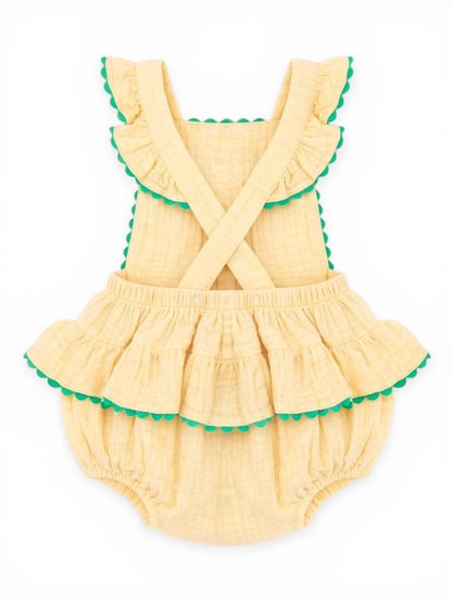 Yellow ruffled baby romper with green scalloped trim, featuring cross-back straps and a layered skirt design.