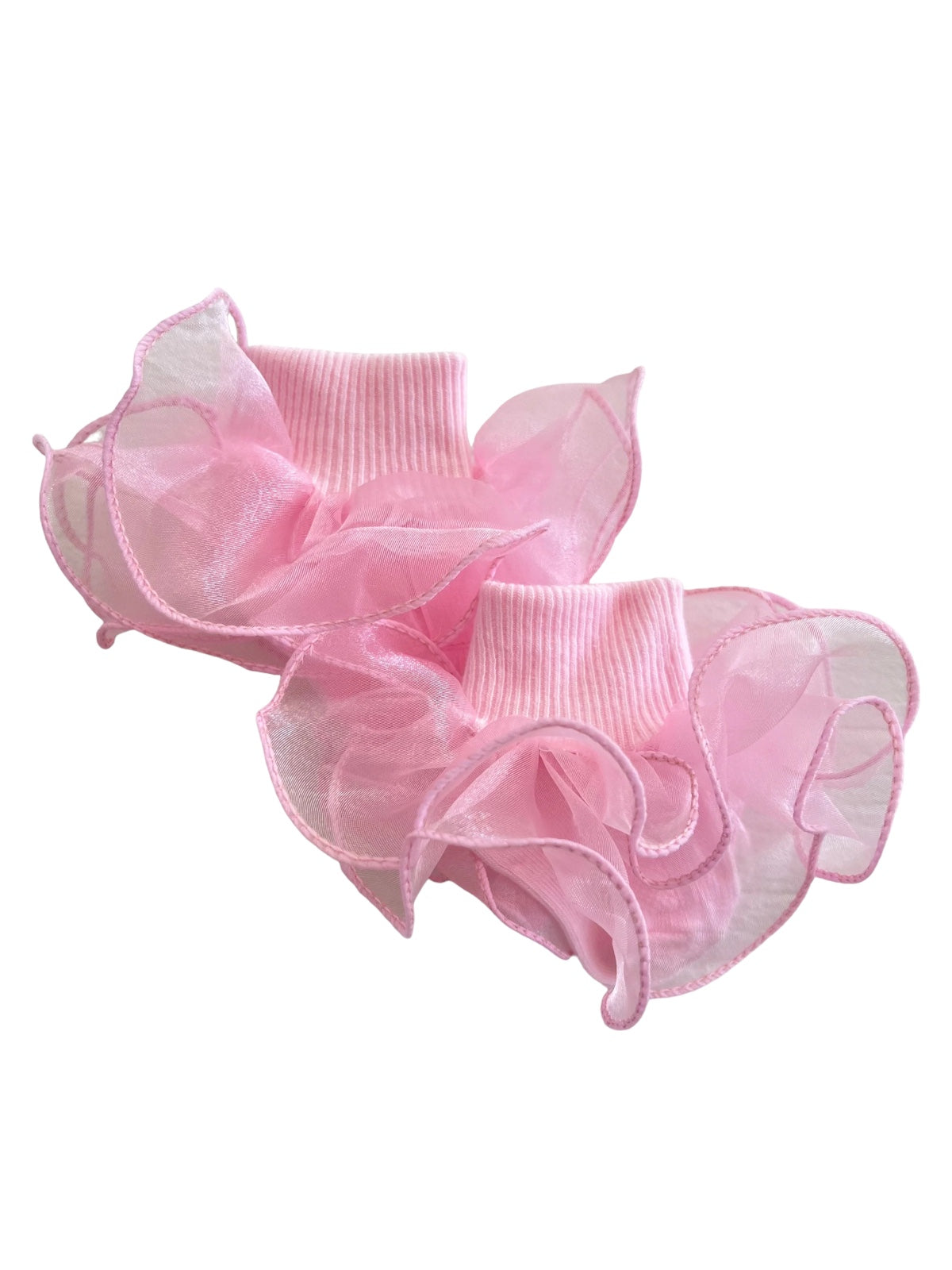 Light pink ruffled socks with sheer fabric and ribbed cuffs, perfect for a playful fashion statement.