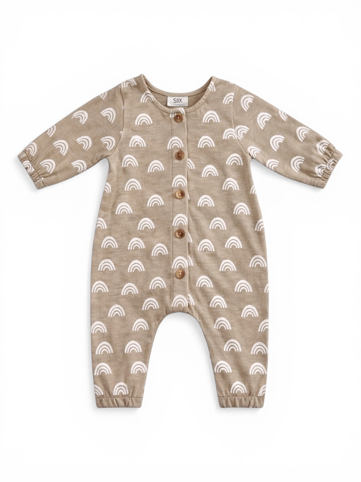 Tan baby romper with white rainbow patterns and wooden buttons, featuring long sleeves and elastic ankle cuffs.