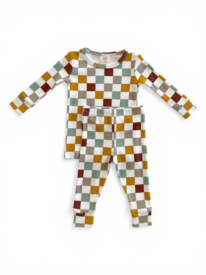 Colorful children's pajama set featuring a long-sleeve top and coordinating pants with checkerboard pattern.