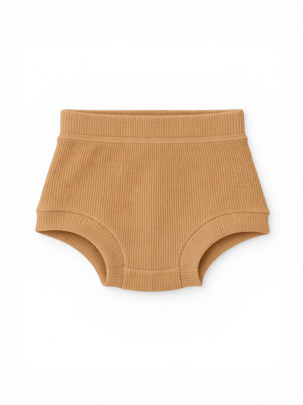 Tan ribbed toddler underwear flat lay on a white background.
