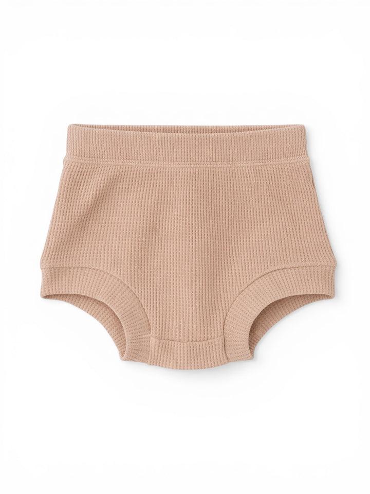Light pink ribbed baby shorts with a comfortable waistband, designed for warmth and ease of movement.