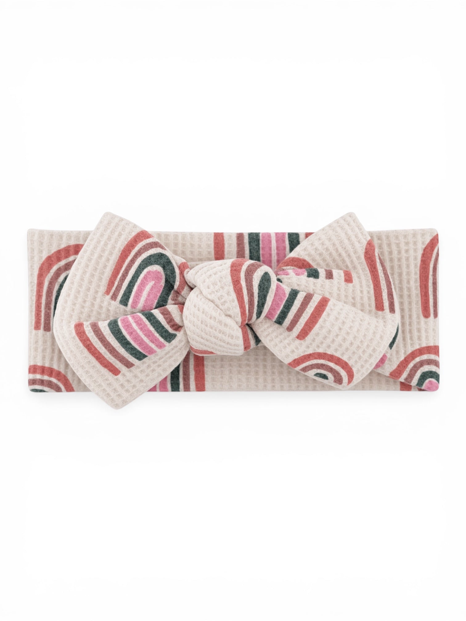 Beige headband with colorful rainbow patterns and a large bow at the center.