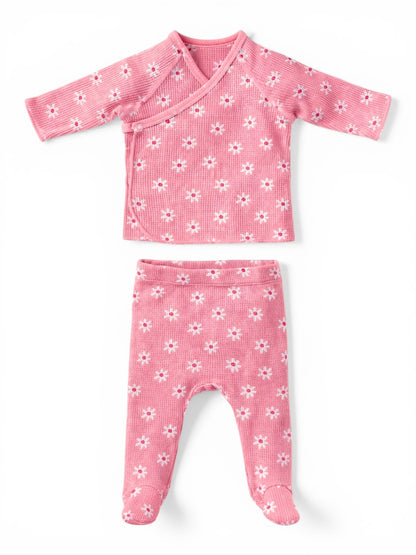 Pink baby outfit featuring a floral-patterned wrap top and matching footed pants.