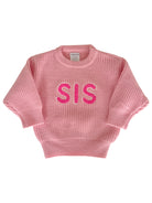 Pink knitted sweater with "SIS" in bright pink letters on the front, designed for infants and toddlers.